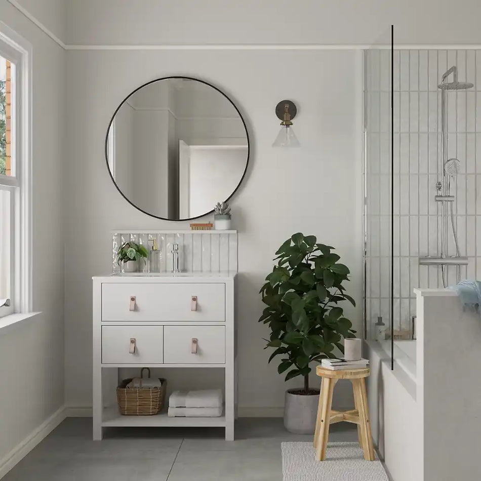 Bathroom interior painted with dulux easycare bathroom pure brilliant white. with a round mirror, white cabinet, plant, and stool.
