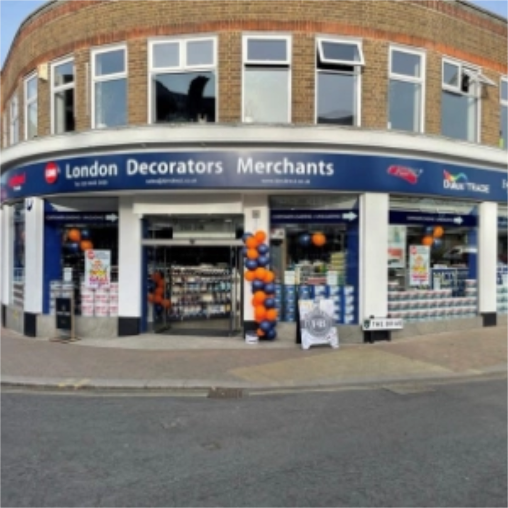 Storefront of London Decorators Merchants in Beckenhamwith decorative balloons on a street corner.