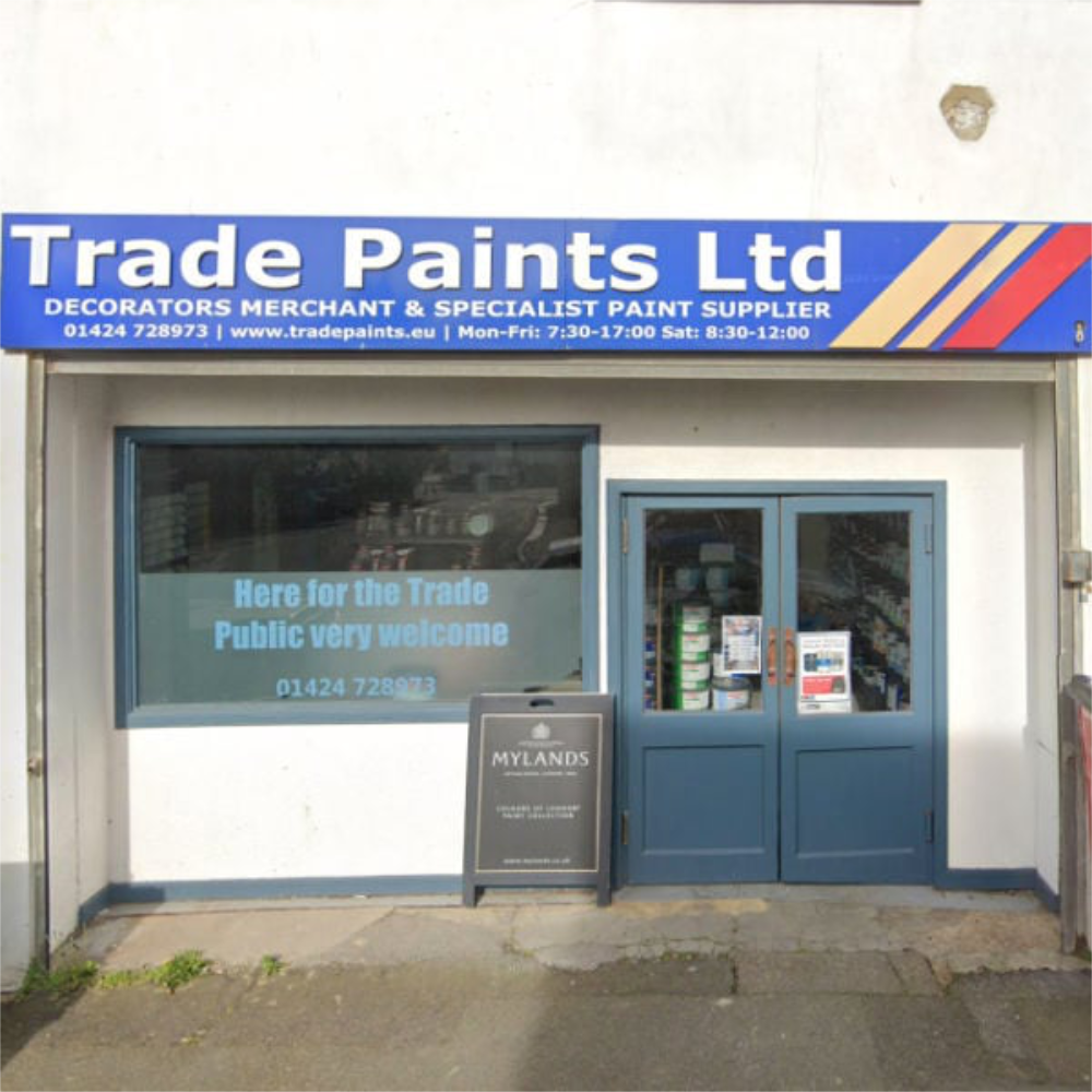 Storefront of LDM Trade Paints in Hastings with blue doors and a sign above.