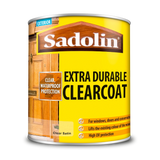 Can of Sadolin Extra Durable Clearcoat with yellow label and wooden door background