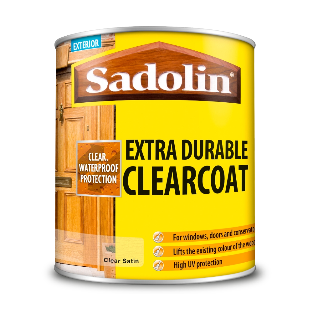 Can of Sadolin Extra Durable Clearcoat with yellow label and wooden door background