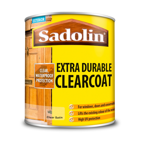 Can of Sadolin Extra Durable Clearcoat with yellow label and wooden door background
