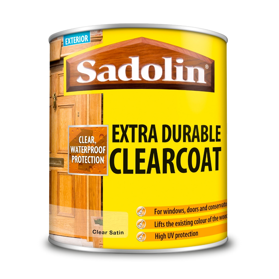 Can of Sadolin Extra Durable Clearcoat with yellow label and wooden door background