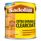 Can of Sadolin Extra Durable Clearcoat with wooden door images on a yellow background